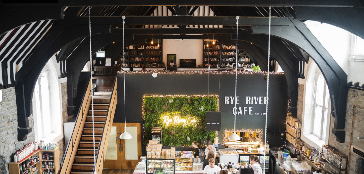 Interior of Rye River Cafe in Kilcock — vaulted ceiling, timber rafters and the cafe counter